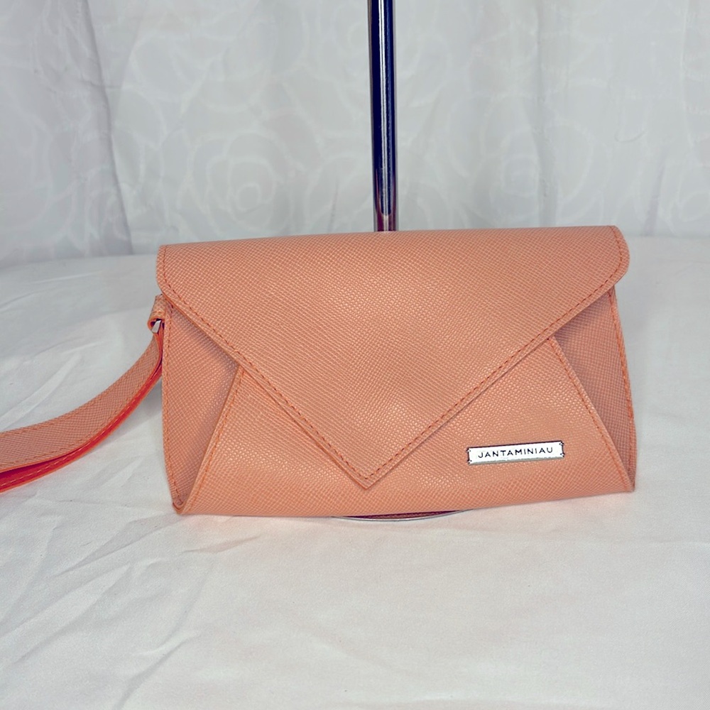 JANTAMINIAU orange faux leather small clutch.